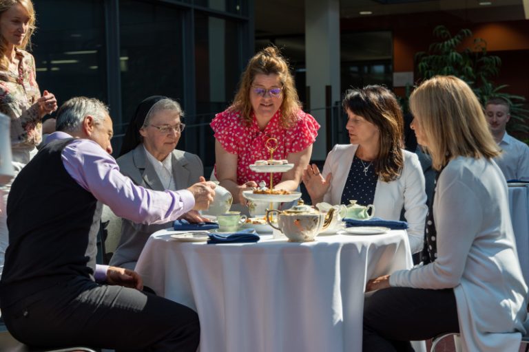 Soeur Lise Tanguay et Caroline Girard, cheffe de la Direction de la philanthropie et des relations avec les diplômées et diplômés attablées avec d’autres invités d’honneur